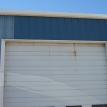 REPAIRED STRUCTURAL OVERHEAD DOOR HEADER, FLASHING AND WALL PANELS